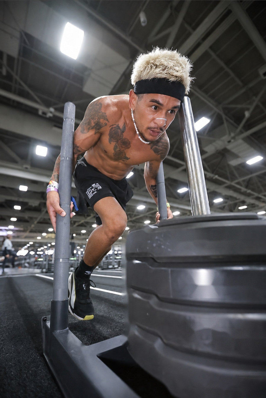 New State founder pushing a heavy sled while training for a HYROX race